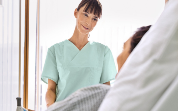 Female Doctor speaking to a patient in a hospital bed